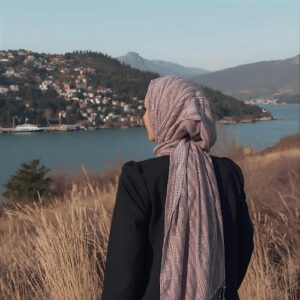 A beautiful, long hijab draped loosely, with the fabric falling gracefully over the shoulders and a soft, natural drape framing the face. This style evokes elegance and simplicity.
