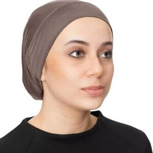A woman wearing a brown Hijab Undercap, which provides a smooth base for the hijab and keeps the hair secure, enhancing the overall look of the hijab.