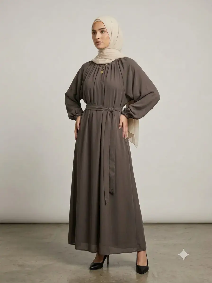 Coffee brown nida abaya with pleated neckline detail, elastic cuff sleeves, and waist belt