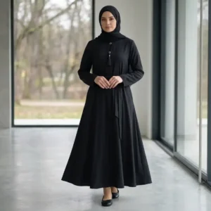 Classic black nida abaya with button and tassel collar detail, waist belt, and A-line flare
