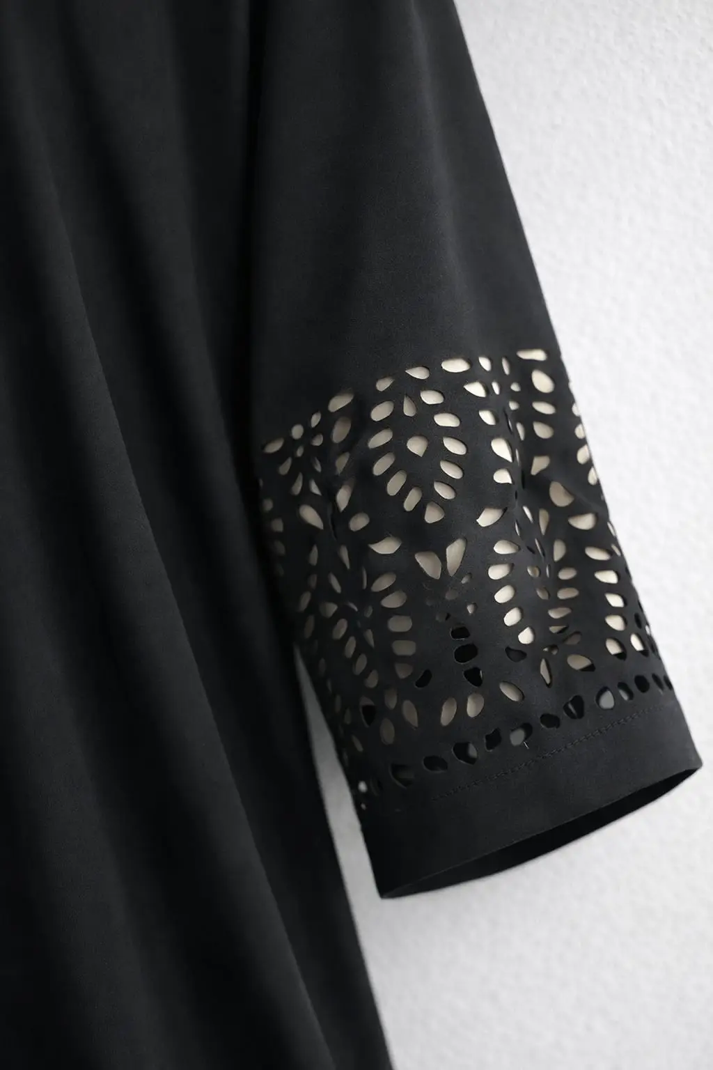 Close-up view of black abaya laser-cut sleeve detailing, premium Georgette fabric from hoorhijabnabayas
