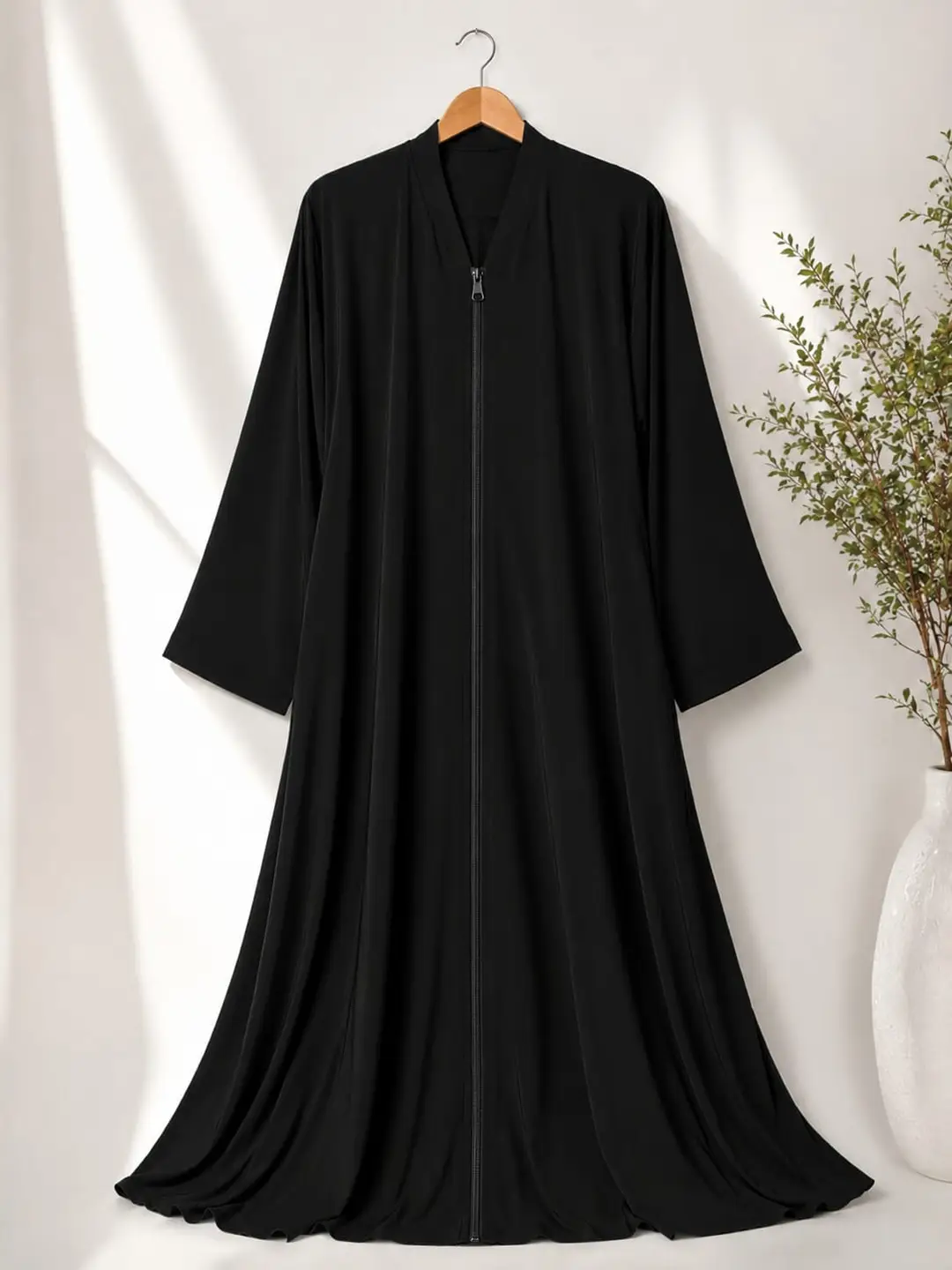 Black full length plain abaya displayed on hanger, soft nida fabric with modern modest design from hoorhijabnabayas